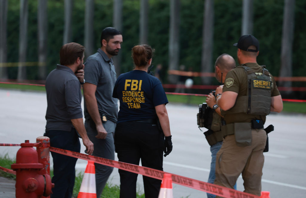 Law enforcement personnel investigate an apparent assassination attempt of former President Donald Trump on September 15, 2024, in West Palm Beach, Florida. (Photo by Joe Raedle/Getty Images)