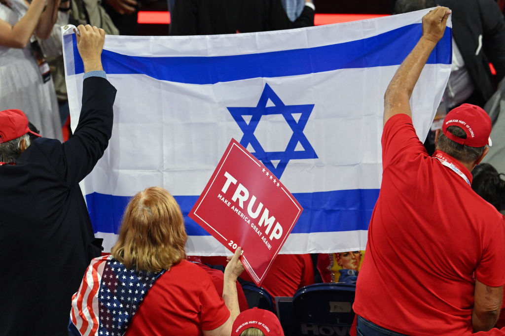 Attendees hold up the flag of Israel during the second day of the 2024 Republican National Convention at the Fiserv Forum in Milwaukee on July 16, 2024. (Photo by ANDREW CABALLERO-REYNOLDS/AFP via Getty Images)