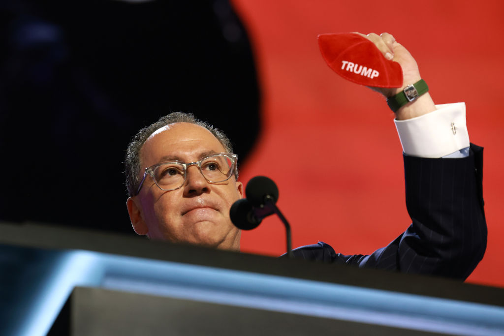 Matt Brooks, CEO of the Republican Jewish Coalition, holds up a kippah bearing the name "Trump" on stage during the Republican National Convention in Milwaukee on July 16, 2024. (Photo by Joe Raedle/Getty Images)