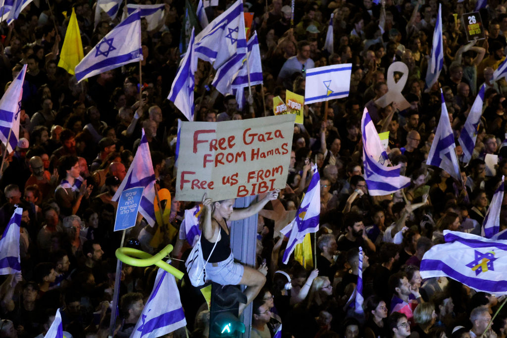 A protester holds up a sign as they join a crowd gathered in Tel Aviv, Israel, on September 1, 2024, to demand a Gaza hostages deal. (Photo by Amir Levy/Getty Images)