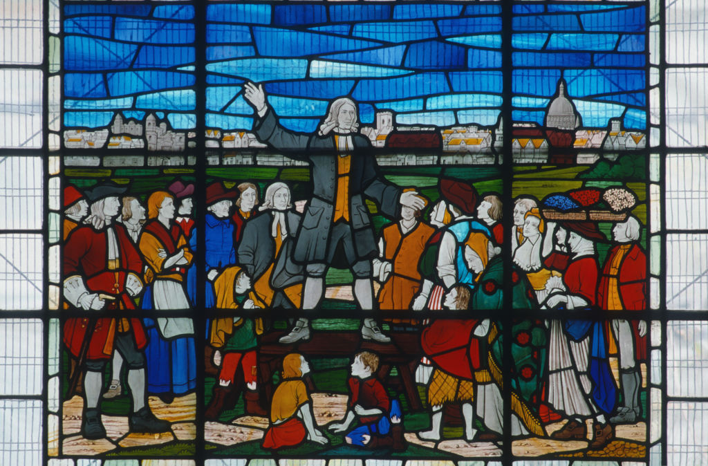 A stained glass window depicts John Wesley, one of the fathers of Methodism, preaching to a crowd in 1738. (Photo By RDImages/Epics/Getty Images)