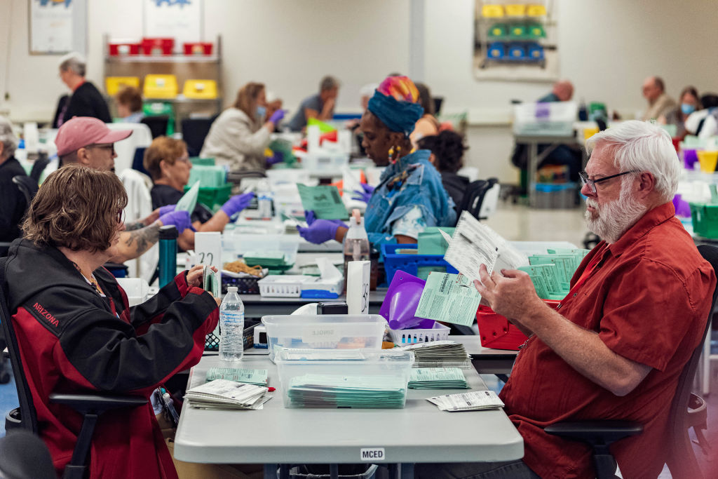 Election workers open envelopes and sort 2024 General Election ballots at the Maricopa County Tabulation and Election Center (MCTEC) in Phoenix, Arizona, on October 23, 2024. (Photo by OLIVIER TOURON/AFP via Getty Images)