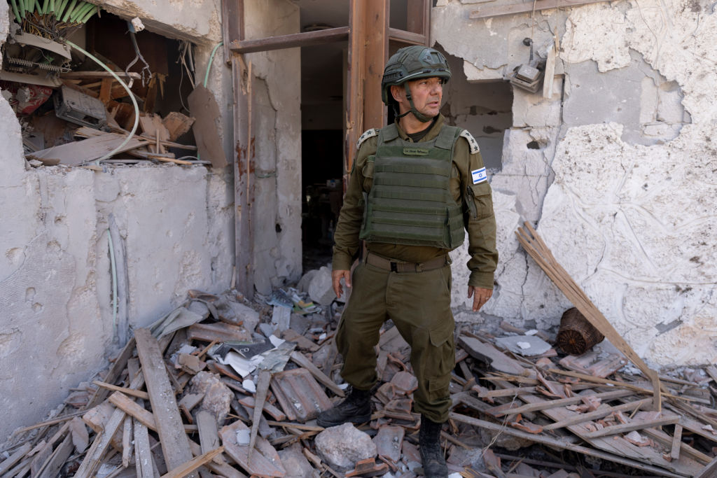 An Israeli soldier inspects a house that was damaged by missile fired by Hezbollah during a media tour to the village on October 15, 2024, in Metula, Israel. (Photo by Amir Levy/Getty Images)