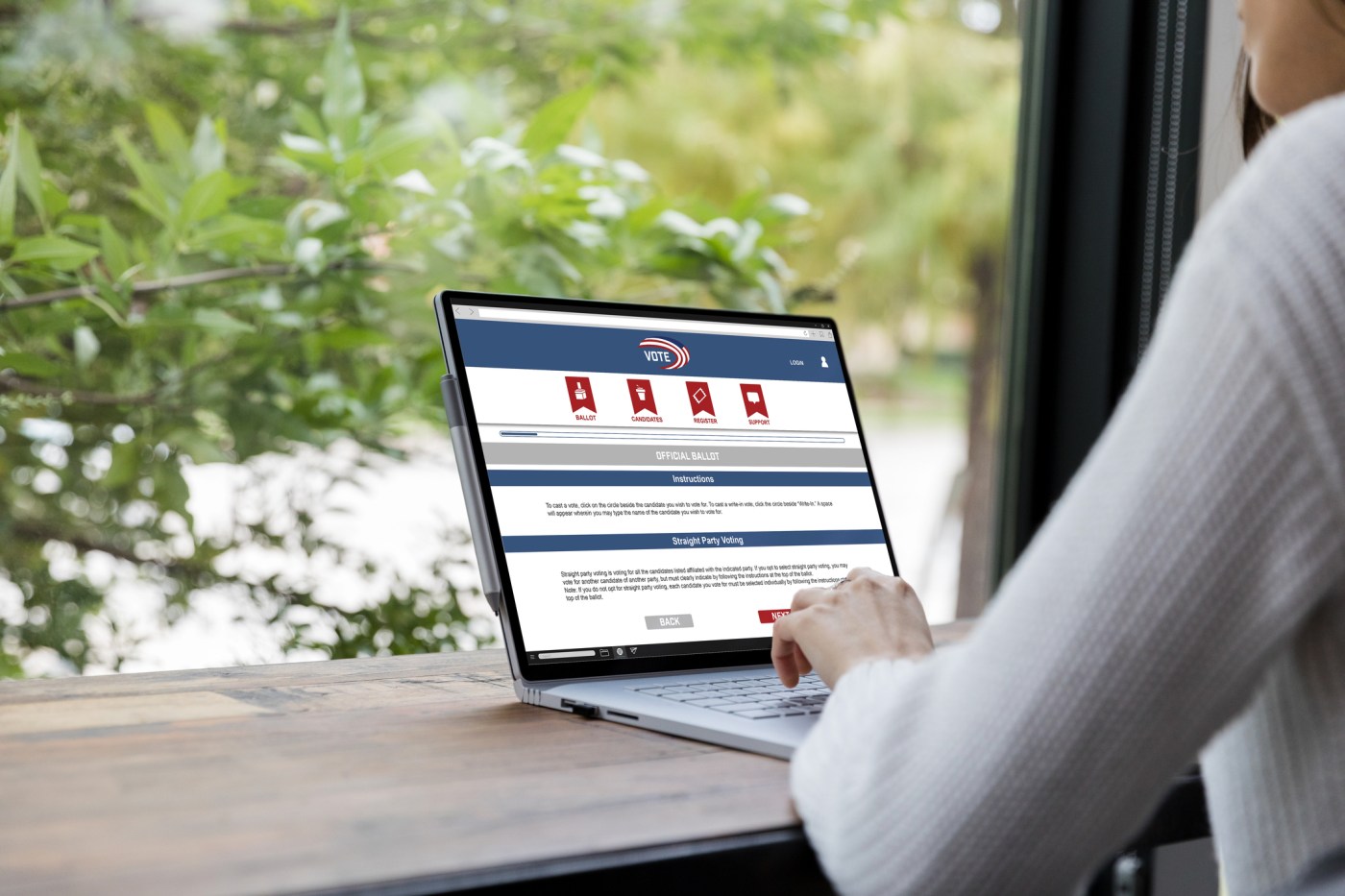 Unrecognizable woman uses laptop to vote online