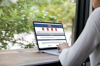 Unrecognizable woman uses laptop to vote online