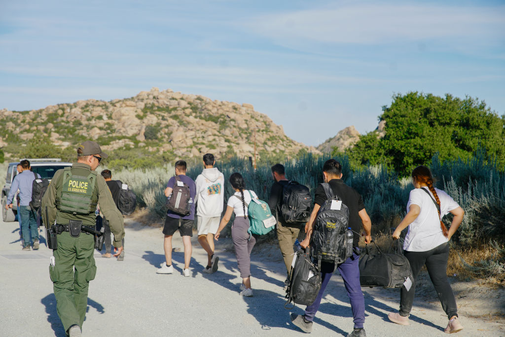 Migrants camping in the border area of Jacumba, California, are detained by U.S. border patrol officers on June 4, 2024, before being transported to a holding facility for deportation. (Photo by Katie McTiernan/Anadolu via Getty Images)