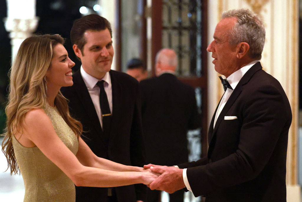 Robert F. Kennedy Jr. (rihgt) talks with former Rep. Matt Gaetz and his wife Ginger Luckey Gaetz at the America First Policy Institute Gala held at Mar-a-Lago on November 14, 2024, in Palm Beach, Florida.  (Photo by Joe Raedle/Getty Images)