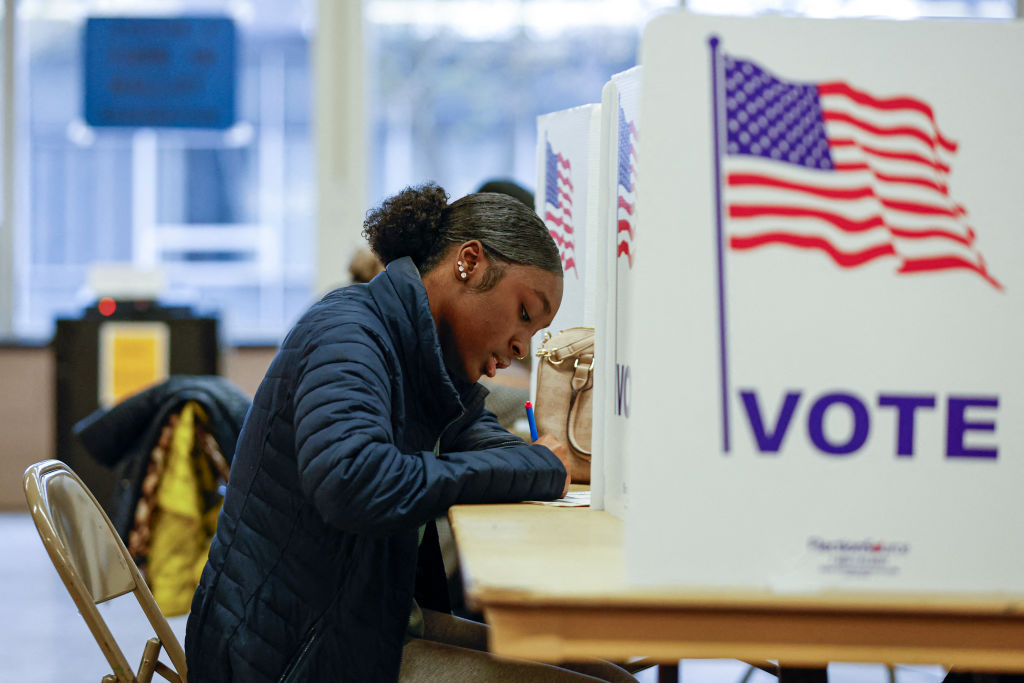 A woman casts her ballot during early voting for the at a polling station at Ottawa Hills High School in Grand Rapids, Michigan, on November 3, 2024. (Photo by KAMIL KRZACZYNSKI/AFP via Getty Images)