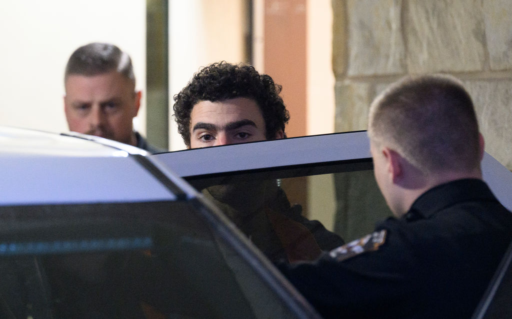 The suspect in the killing of UnitedHealthcare CEO Brian Thompson, Luigi Mangione, is led from the Blair County Courthouse after an extradition hearing December 10, 2024, in Hollidaysburg, Pennsylvania. (Photo by Jeff Swensen/Getty Images)