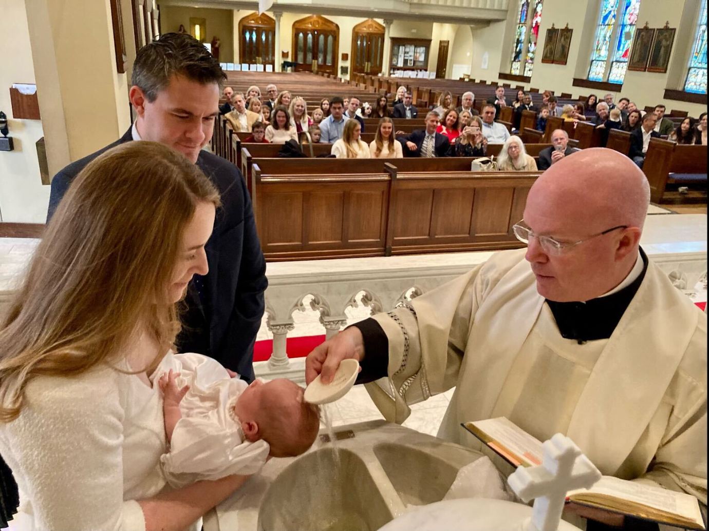 Monsignor Roger Landry baptizes Mary Elizabeth McCormack as her parents, John and Lauren, look on. (Photo courtesy of John and Lauren McCormack)