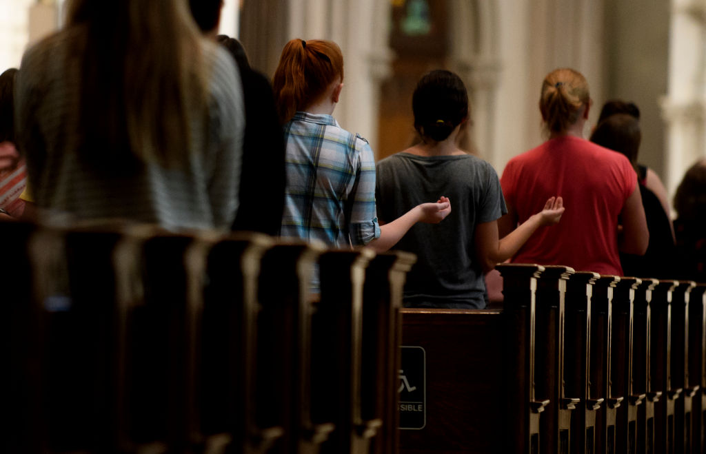 Parishioners worship during Mass at St. Paul Cathedral on August 15, 2018, in Pittsburgh, Pennsylvania. (Photo by Jeff Swensen/Getty Images)