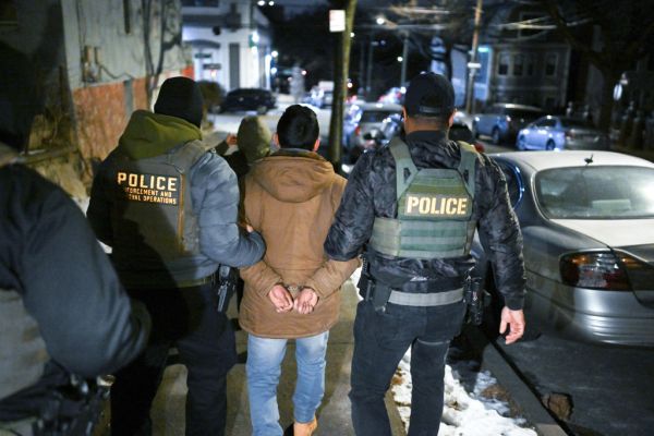 Law enforcement officers walk with a detainee as he was arrested during ICE-led operations to apprehend illegal immigrants on January 28, 2025 in New York, NY. (Photo by Matt McClain/The Washington Post via Getty Images)