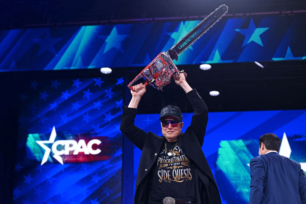 Elon Musk holds a chainsaw reading "Long live freedom, damn it" during the Conservative Political Action Conference (CPAC) at the Gaylord National Resort & Convention Center in Oxon Hill, Maryland, on February 20, 2025. (Photo by Saul Loeb/AFP via Getty Images)