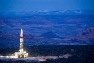 Dusk view of natural gas drill rig near Dead Horse Point in SE Utah, USA Though this rig is on land managed by the Bureau of Land  Management, the surrounding area is a checker board of National Park and National Forest Land.