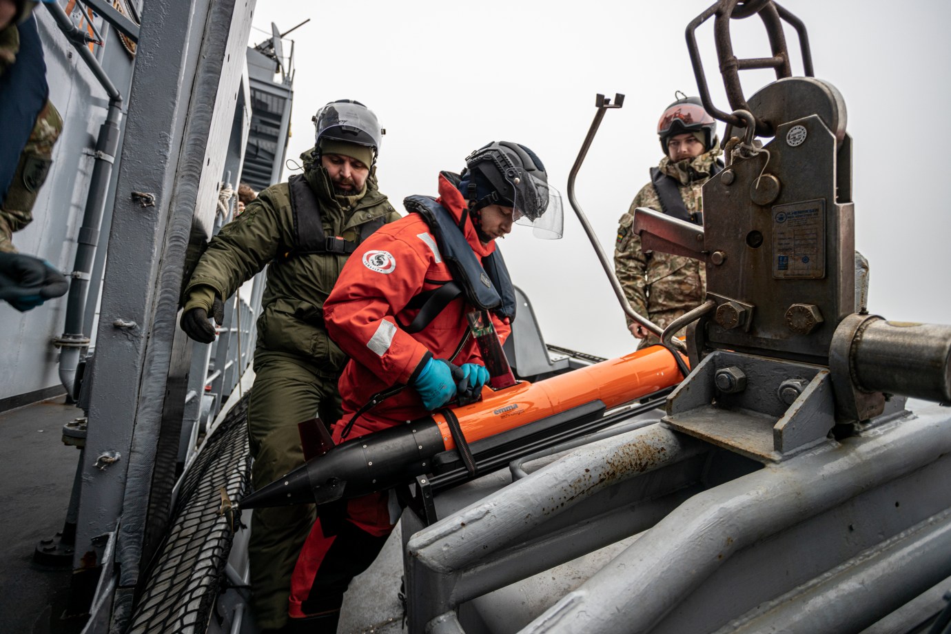 Drone operators launch a “light autonomous underwater vehicle” over an undersea infrastructure. (Photograph by Théo Prouvost)