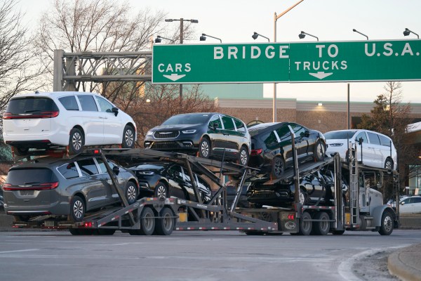 A truck carrying vehicles prepares to cross into the U.S. from Canada at the Ambassador Bridge in Windsor, Ontario, on March 8, 2025.(Photo by Geoff Robins / AFP) (Photo by GEOFF ROBINS/AFP via Getty Images)