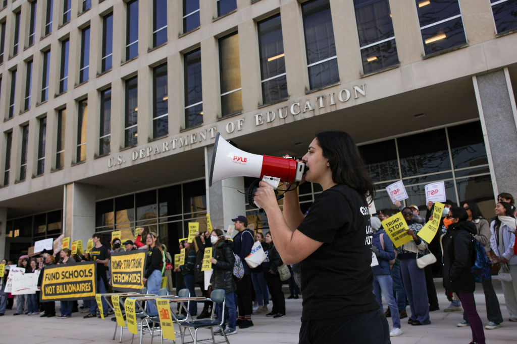 Demonstrators gather outside of the offices of the U.S. Department of Education in Washington, D.C. on March 13, 2025 to protest against mass layoffs and budget cuts at the agency. (Photo by BRYAN DOZIER/Middle East Images/AFP via Getty Images)