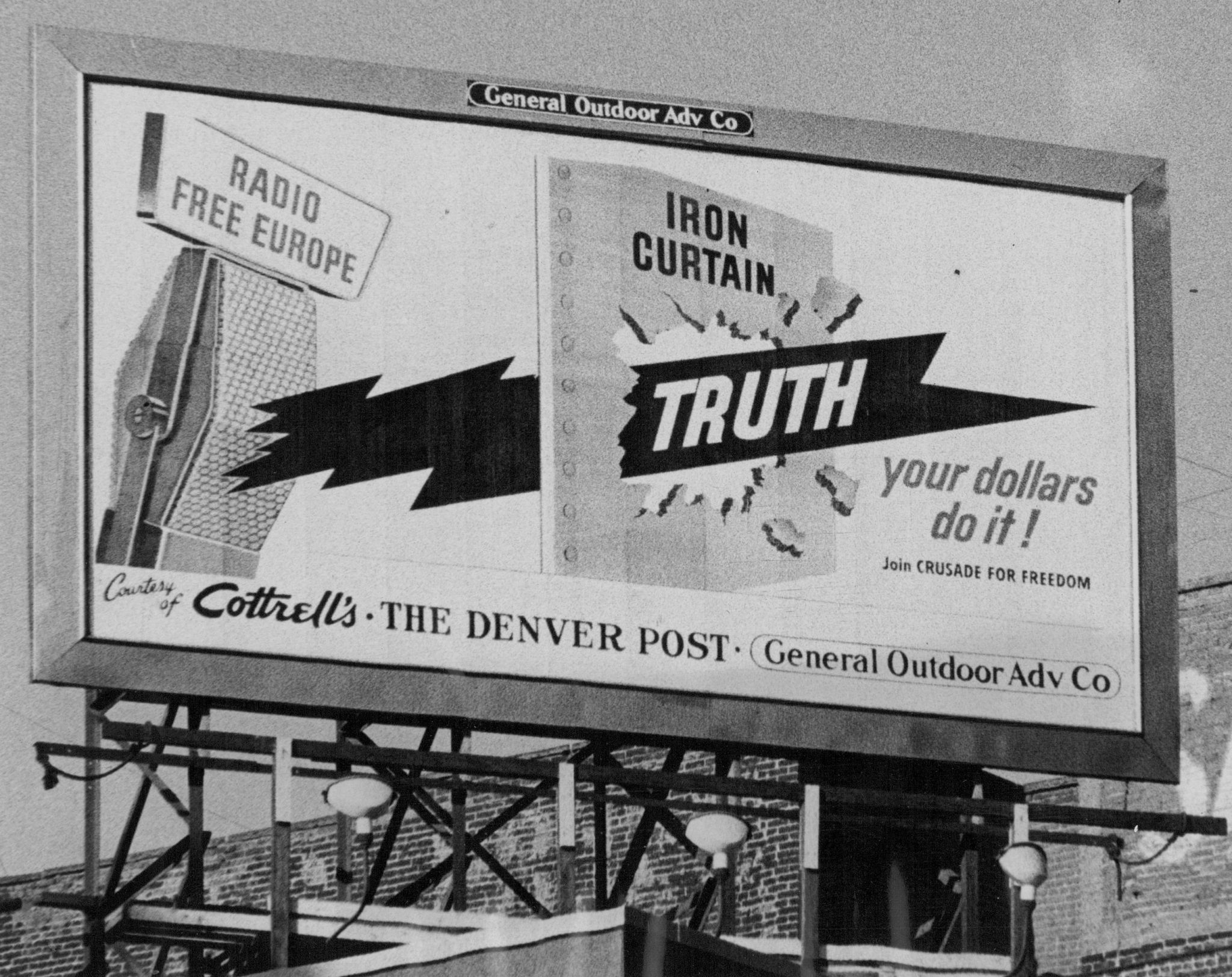 A sign atop Cottrell's store urges Denverites to support the operations of Radio Free Europe in broadcasting the truth to millions behind the Iron Curtain. (Photo By Floyd H. McCall/The Denver Post via Getty Images)