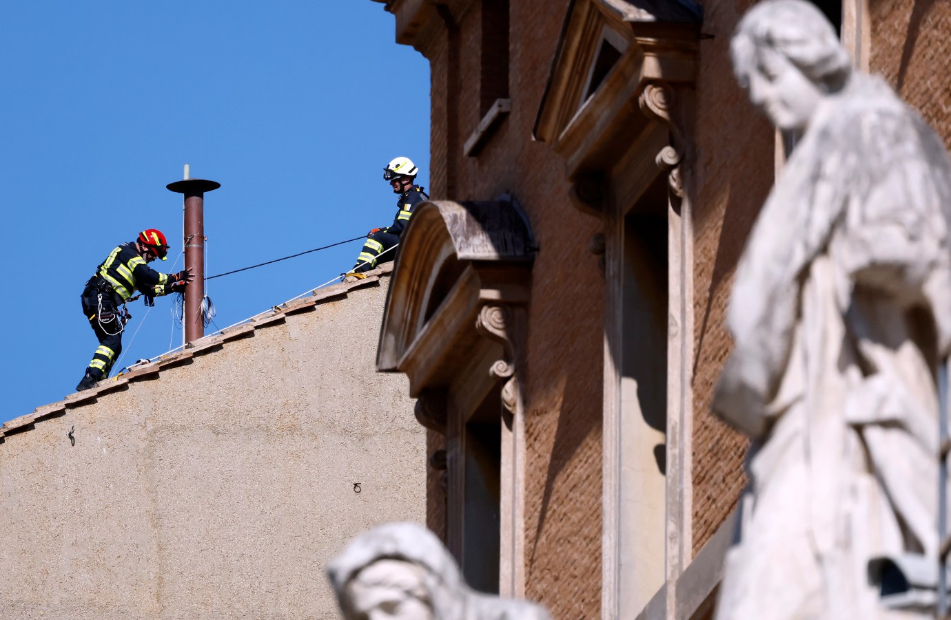 Firefighters install a temporary chimney on the roof of the Sistine Chapel on Friday in Vatican City, Vatican. The chimney used to communicate the choosing of a new Pope is erected on the roof of the Sistine Chapel ahead of a papal conclave beginning May 7. Cardinals vote for their chosen candidate, and if there is no majority, the ballots are burnt with additives giving off black smoke. Once there is a majority, the votes are burnt without additives, giving off the white smoke signal that a new pope is chosen. (Photo by Mario Tama/Getty Images)