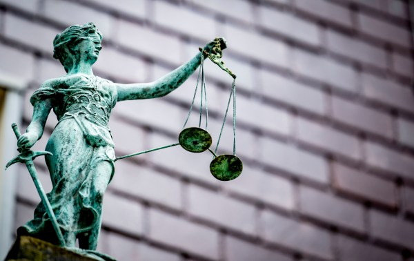 A weathered statue of Lady Justice. (Photo via Caption Photo Gallery/Getty Images)