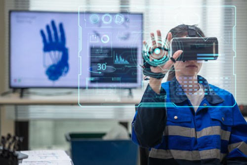 Multiracial engineer perfects robotic hand control using digitization ,coding, AI, and automation for future tech in laboratory room.