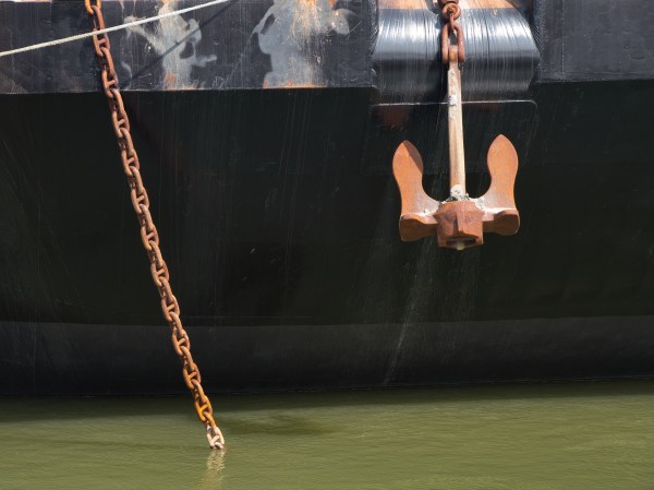A transport barge with rusted nautical hardware hanging off the bow. (Photo by JC Shamrock/Getty Images)