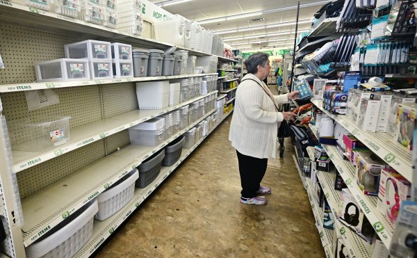 Empty shelves are seen as a woman shops for items at a Dollar Tree store on April 28, 2025, in Alhambra, California. (Photo by Frederic J. Brown/AFP/Getty Images)
