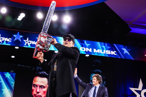 Elon Musk holds a personalized chainsaw given by Argentine President Javier Milei at the Conservative Political Action Conference (CPAC) at the National Harbor in Oxon Hill, Maryland, on February 20, 2025. (Photo by Valerie Plesch/ Washington Post/Getty Images)