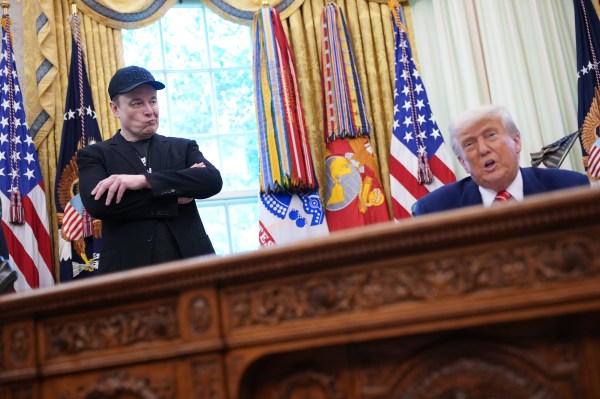 Tesla CEO Elon Musk listens as President Donald Trump speaks to reporters in the Oval Office of the White House on May 30, 2025 in Washington, D.C. (Photo by Kevin Dietsch/Getty Images)