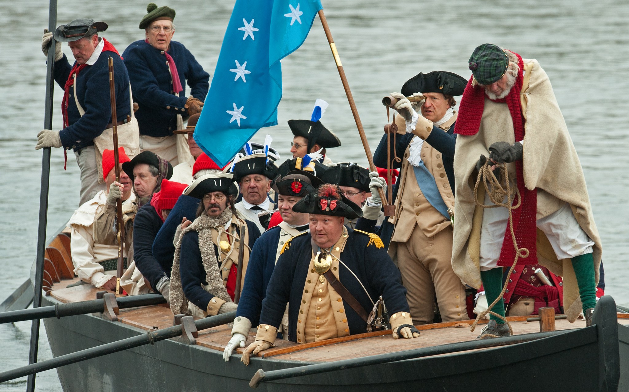 John Godzieba, holding a looking glass, plays the role of George Washington during the annual re-enactment of George Washington crossing the Delaware River at Washington Crossing Historic Park in Pennsylvania, on December 25, 2010. (Photo by PAUL J. RICHARDS/AFP via Getty Images)