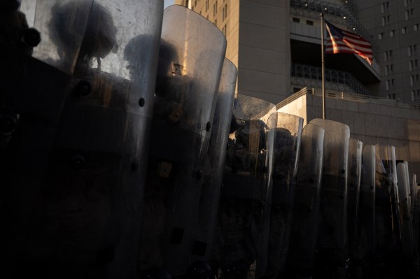 U.S. Marines and members of the California National Guard stand in line at the entrance of the Metropolitan Detention Center following federal immigration operations in Los Angeles on July 4, 2025. (Photo by EtienneT Laurent/AFP via Getty Images)
