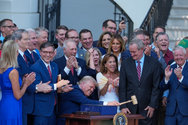 President Donald Trump, joined by Republican lawmakers, signs the One Big Beautiful Bill Act into law on the South Lawn of the White House on July 4, 2025, in Washington, D.C. (Photo by Eric Lee/Getty Images)