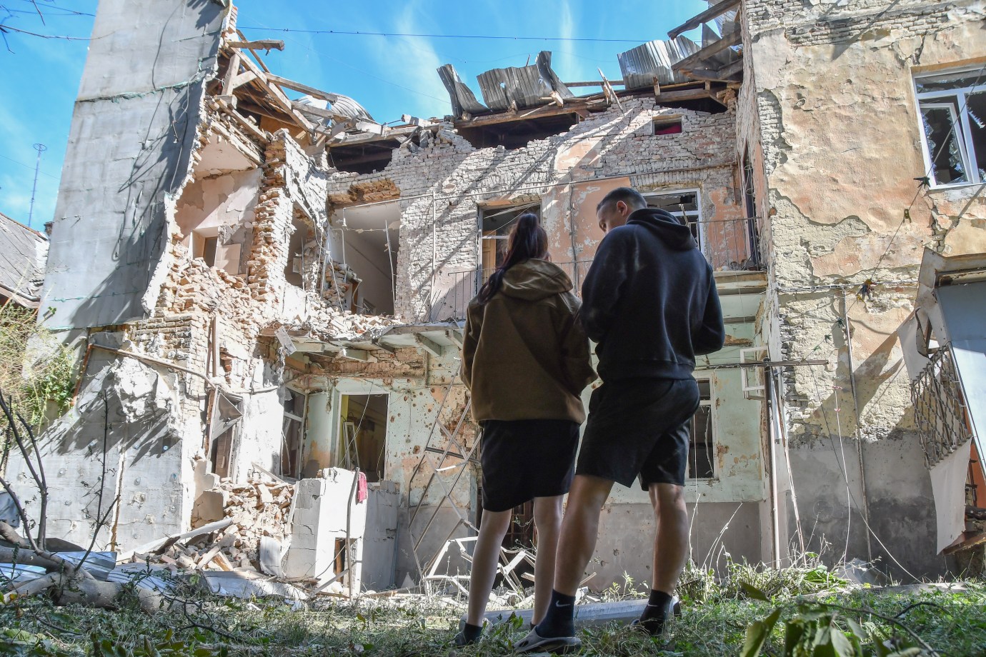 People stand near a two-story residential building in Lviv, Ukraine, that was partially destroyed by a Russian drones' strike on July 12, 2025. (Photo by Mykola Tys/Global Images Ukraine via Getty Images)
