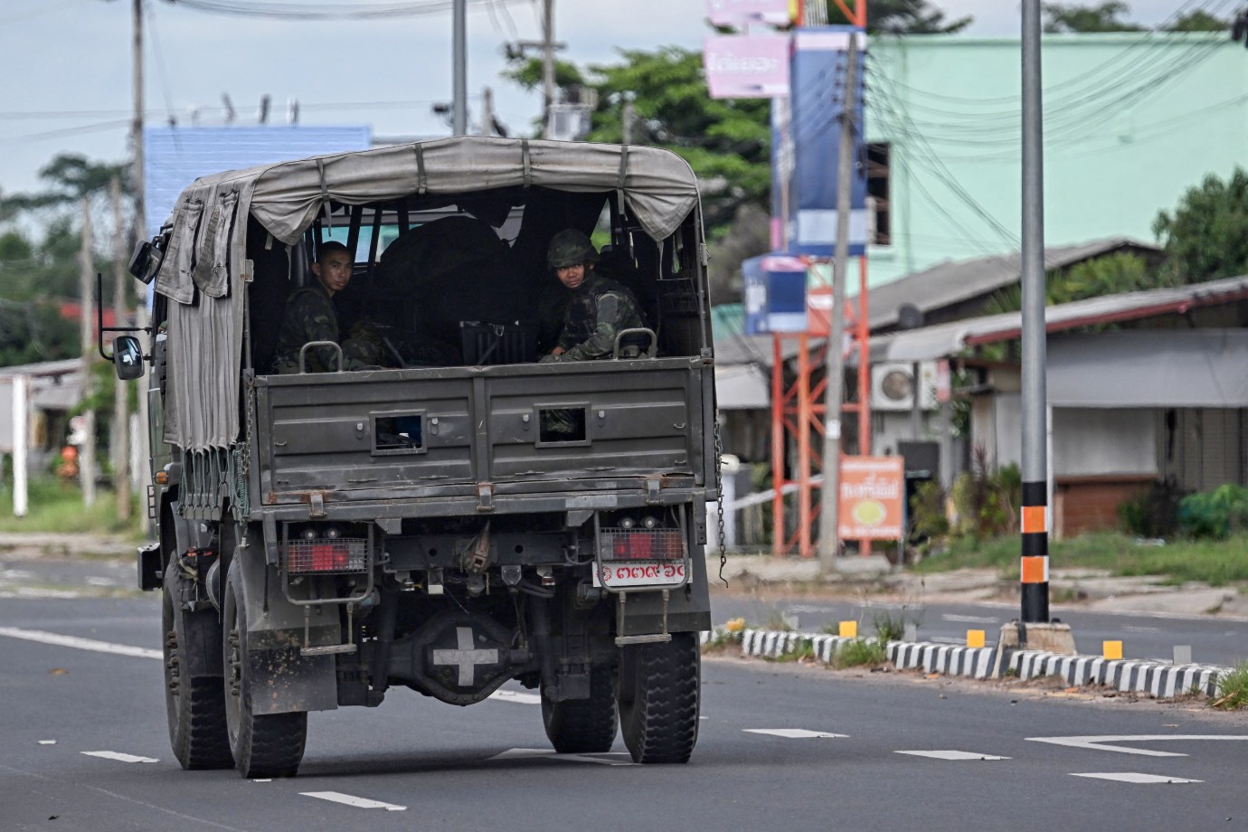 Royal Thai Army soldiers sit in the back of an army vehicle in the Thai border province of Surin on July 29, 2025. A shaky ceasefire between Thailand and Cambodia appeared to be holding July 29, as military commanders met despite Bangkok's allegations the truce had been breached with overnight skirmishes. (Photo by Lillian SUWANRUMPHA / AFP/Getty Images)