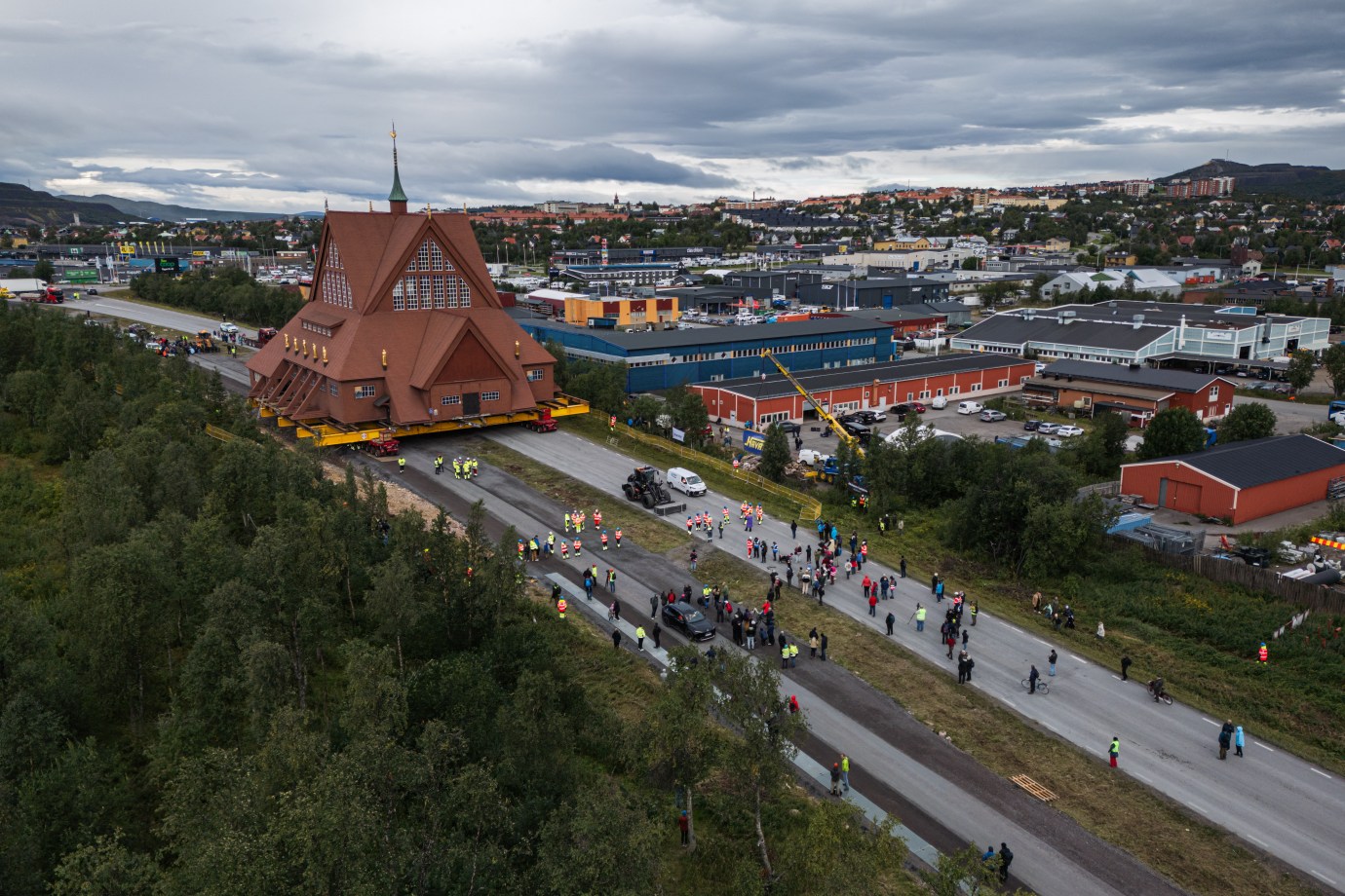The wooden Kiruna Church is moved to its new location in Kiruna, Sweden, on August 20, 2025. The church moved about 3 miles away due to expansion of the world’s largest iron-ore mine, underneath the town. Built in a Sami architectural style, the church was completed in 1912 and has landed atop lists of Sweden’s most beautiful buildings. (Photo by Jonathan Nackstrand/AFP via Getty Images)