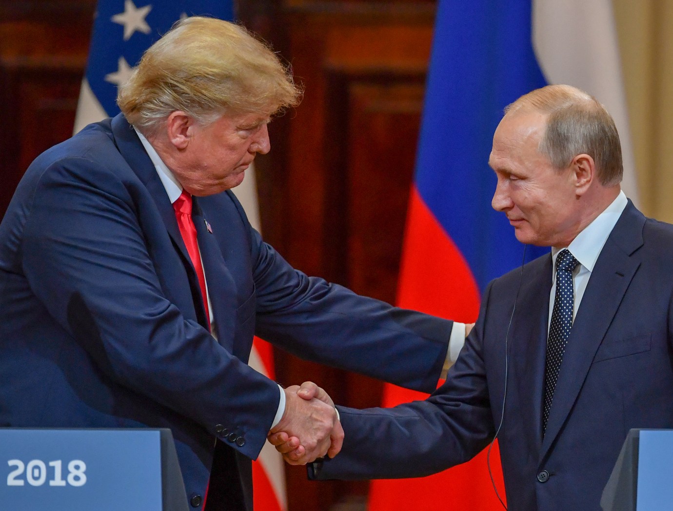 President Donald Trump and Russia's President Vladimir Putin shake hands before attending a joint press conference after a meeting at the Presidential Palace in Helsinki, on July 16, 2018. (Photo by YURI KADOBNOV/AFP via Getty Images)