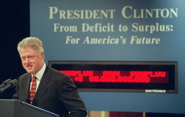 President Bill Clinton announces on September 30, 1998, that the budget surplus for the 1997-1998 fiscal year is more than $70 billion. (Photo by Joyce Naltchayan/AFP via Getty Images)