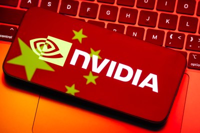 Nvidia logo displayed on smartphone with Chinese flag reflection from computer screen